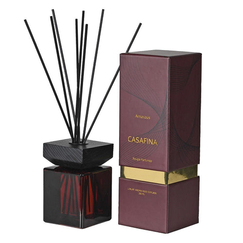 Oud and vanilla reed diffuser in a glass bottle with natural reeds
