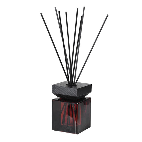 Oud and vanilla reed diffuser in a glass bottle with natural reeds